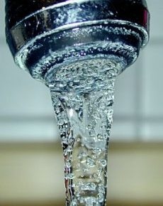 Close-up view of water flowing from a faucet.