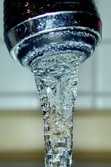 Close-up view of water flowing from a faucet.
