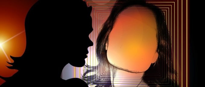A silhouette of a woman symbolizing emotional trauma against a glowing background.