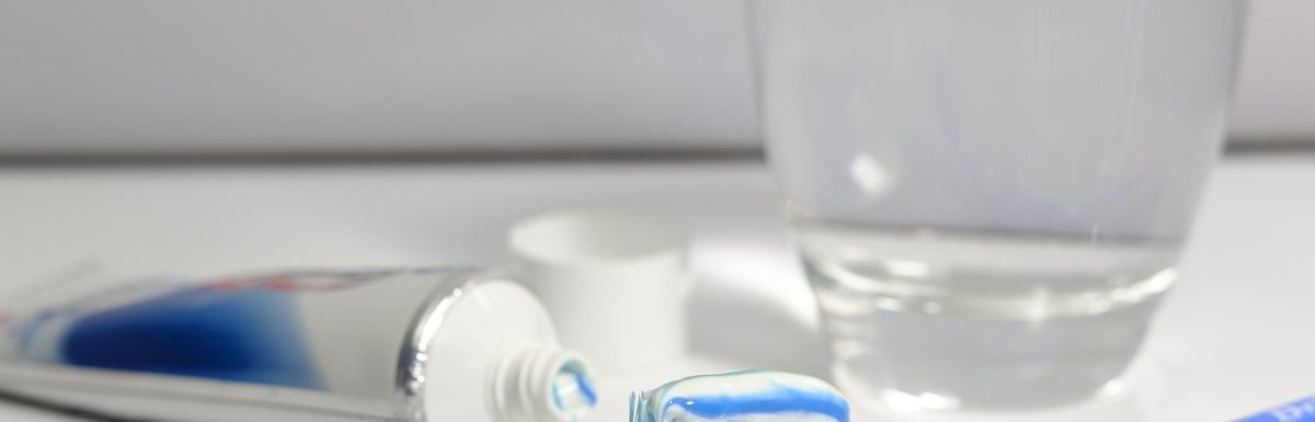 A tube of fluoride toothpaste and a loaded toothbrush.