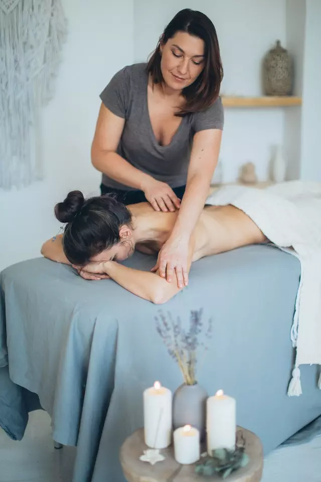 A woman receiving a relaxing massage in a spa, promoting holistic health.