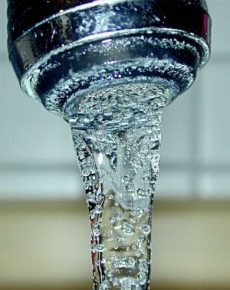 Close-up view of water flowing from a faucet.